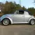 1970 Volkswagen Beetle Convertible.  Bluish silver with a dark blue cloth top.