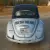 1970 Volkswagen Beetle Convertible.  Bluish silver with a dark blue cloth top.