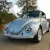 1970 Volkswagen Beetle Convertible.  Bluish silver with a dark blue cloth top.
