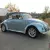1970 Volkswagen Beetle Convertible.  Bluish silver with a dark blue cloth top.