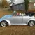 1970 Volkswagen Beetle Convertible.  Bluish silver with a dark blue cloth top.