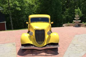 Yellow 1934 Ford 3 window coupe built by fiberfab, engine is Chevy 502ci. Photo