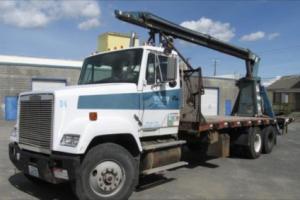 freightliner semi with flatbed and jiffy jib boom crane