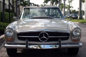 1969 MERCEDES 280 SL. BEIGE WITH BROWN LEATHER. AC. TWO TOPS. EXCELLENT CAR.