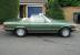 Mercedes Benz 450SL R107 1975 in two tone metallic green and black soft top