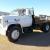 5 ton flatbed diesel truck, white single cab, bench seat, black 12' long