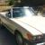 1987 MERCEDES BENZ 560SL COUPE WITH HARD AND SOFT TOP, IVORY WITH BLUE INTERIOR