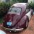 Maroon and white VW Beetle
